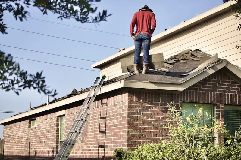 Professional roofer working on a residential roof in Nadeau